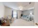 Inviting bedroom with carpet, a ceiling fan, and a peaceful seating area at 2307 Needle Palm Dr, Edgewater, FL 32141
