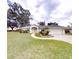 Charming single-story home with a well-manicured lawn and an inviting walkway to the front door at 2307 Needle Palm Dr, Edgewater, FL 32141
