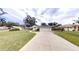 Charming single-story home with well-maintained lawn and a paved driveway leading to an attached garage at 2307 Needle Palm Dr, Edgewater, FL 32141