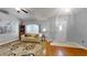 Comfortable living room with hardwood flooring, neutral walls, and a front door entrance at 2307 Needle Palm Dr, Edgewater, FL 32141