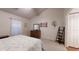 Cozy main bedroom features a large window, dresser, decorative wall art, and an accent ladder shelf at 2307 Needle Palm Dr, Edgewater, FL 32141