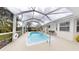 This screened-in pool offers an outdoor space for relaxation and recreation at 2307 Needle Palm Dr, Edgewater, FL 32141