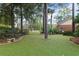 Lush backyard featuring mature trees, green lawn, and a well-maintained landscape with charming benches at 2333 Southern Pines Pl, Deland, FL 32724