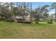 Expansive backyard features mature trees and a spacious deck, perfect for outdoor entertaining and enjoying nature at 2333 Southern Pines Pl, Deland, FL 32724