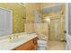 Bathroom featuring marble countertop, shower, and gold fixtures at 2333 Southern Pines Pl, Deland, FL 32724