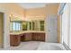 Bathroom featuring a vanity with a large mirror, cabinetry, and a nearby walk in shower at 2333 Southern Pines Pl, Deland, FL 32724