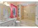 Bathroom with a tub, vanity, toilet, and wallpaper at 2333 Southern Pines Pl, Deland, FL 32724