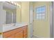 Bathroom with wood vanity, large mirror, neutral walls, and a shower/tub combination at 2333 Southern Pines Pl, Deland, FL 32724