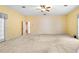 Large bedroom featuring a door to the outdoors and a large, bright window, with neutral walls and carpet at 2333 Southern Pines Pl, Deland, FL 32724
