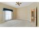 Spacious bedroom with carpet, ceiling fan, and a walk in closet at 2333 Southern Pines Pl, Deland, FL 32724