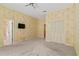 Large bedroom with attached bathroom, closet, and TV at 2333 Southern Pines Pl, Deland, FL 32724