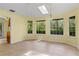 Bright dining room with large windows, skylight, and tile flooring for a cozy, sun-filled atmosphere at 2333 Southern Pines Pl, Deland, FL 32724