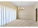 Bright dining room featuring a traditional chandelier, neutral decor, and large windows for natural light at 2333 Southern Pines Pl, Deland, FL 32724