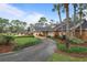 Charming brick home with a long driveway, mature trees, and beautifully landscaped front yard at 2333 Southern Pines Pl, Deland, FL 32724