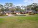 Expansive estate featuring lush green lawn, circular driveway, and mature landscaping and three-car garage at 2333 Southern Pines Pl, Deland, FL 32724