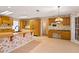 Retro kitchen featuring a large island, warm wood cabinets, and floral wallpaper at 2333 Southern Pines Pl, Deland, FL 32724