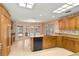 Bright kitchen area with a center island, skylights, and French doors leading to the pool area outside at 2333 Southern Pines Pl, Deland, FL 32724