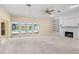 Spacious living room featuring a fireplace, built-in shelves, and pool view through French doors at 2333 Southern Pines Pl, Deland, FL 32724