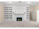 Living room with a fireplace, built-in shelves, and neutral carpet at 2333 Southern Pines Pl, Deland, FL 32724