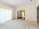 Bright living room with large window, doorway to entry, and neutral decor creating a versatile space at 2333 Southern Pines Pl, Deland, FL 32724