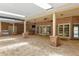 Spacious outdoor patio with covered ceiling, brick columns, bar area, and multiple doors at 2333 Southern Pines Pl, Deland, FL 32724