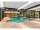 Spacious indoor pool surrounded by patio and large windows at 2333 Southern Pines Pl, Deland, FL 32724