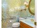 Charming powder room with wood vanity, patterned wallpaper, and updated fixtures at 2333 Southern Pines Pl, Deland, FL 32724