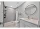 Modern bathroom featuring subway tile, a walk-in shower, hexagon tile floor, and a round mirror at 2347 Cr 546A, Bushnell, FL 33513