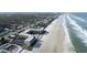Aerial view of oceanfront condos with multiple pools and beach access at 2401 S Atlantic Ave # A604, New Smyrna Beach, FL 32169