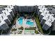 Aerial view of condo complex with pools, shuffleboard courts, and meticulous landscaping at 2401 S Atlantic Ave # A604, New Smyrna Beach, FL 32169