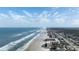 Expansive aerial view of the coastline, showcasing the beach, ocean, and condo buildings at 2401 S Atlantic Ave # A604, New Smyrna Beach, FL 32169