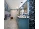 Modern bathroom with double sinks, tiled accent wall, and walk-in shower with glass door at 2401 S Atlantic Ave # A604, New Smyrna Beach, FL 32169