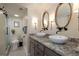 Bathroom featuring double vessel sinks, granite countertops, and modern fixtures at 2401 S Atlantic Ave # A604, New Smyrna Beach, FL 32169