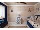 Nautical themed bedroom with wood paneling, decorative fish accents, and daybed at 2401 S Atlantic Ave # A604, New Smyrna Beach, FL 32169