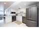 Bright kitchen with stainless steel appliances, white cabinetry, and breakfast bar with ocean view at 2401 S Atlantic Ave # A604, New Smyrna Beach, FL 32169