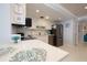 Modern kitchen with white cabinets, stainless steel appliances, and decorative accents at 2401 S Atlantic Ave # A604, New Smyrna Beach, FL 32169