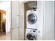 Laundry closet with stacked washer and dryer next to a bathroom at 2401 S Atlantic Ave # A604, New Smyrna Beach, FL 32169