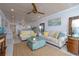 Bright living room with two sofas, wood ceiling, area rug and turquoise accents at 2401 S Atlantic Ave # A604, New Smyrna Beach, FL 32169
