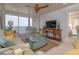 Living room with comfortable seating, stylish decor, and balcony access with ocean view at 2401 S Atlantic Ave # A604, New Smyrna Beach, FL 32169
