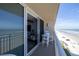 Balcony view overlooking the beach, with table and chairs for outdoor enjoyment at 2401 S Atlantic Ave # D301, New Smyrna Beach, FL 32169