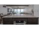 Kitchen view of the ocean and living room with stainless steel appliances and dining area at 2401 S Atlantic Ave # D301, New Smyrna Beach, FL 32169