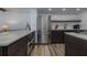 A well-lit kitchen features stainless steel appliances, wood flooring, and ample counter space at 2401 S Atlantic Ave # D301, New Smyrna Beach, FL 32169