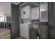 Functional laundry room featuring stacked washer and dryer, with grey shaker style doors at 2401 S Atlantic Ave # D301, New Smyrna Beach, FL 32169