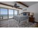 Inviting bedroom with an ocean view, ceiling fan, and light-filled atmosphere at 2401 S Atlantic Ave # D301, New Smyrna Beach, FL 32169
