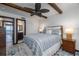 Comfortable bedroom with a ceiling fan and view into the bathroom at 2401 S Atlantic Ave # D301, New Smyrna Beach, FL 32169