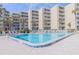 Resort-style pool is surrounded by comfortable seating and lush greenery overlooking the ocean at 2401 S Atlantic Ave # D301, New Smyrna Beach, FL 32169