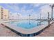 Enjoy the community pool overlooking the beach with ample lounge chairs and palm trees at 2401 S Atlantic Ave # D301, New Smyrna Beach, FL 32169