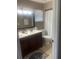 Bathroom with double sinks, dark wood cabinet and a shower/tub combo at 2409 Victory Palm Dr, Edgewater, FL 32141