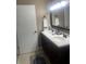 Bathroom vanity features double sinks, dark wood cabinets, and granite countertop at 2409 Victory Palm Dr, Edgewater, FL 32141