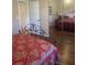 Cozy bedroom featuring a bed with decorative red paisley bedding and mirrored closet doors at 2409 Victory Palm Dr, Edgewater, FL 32141